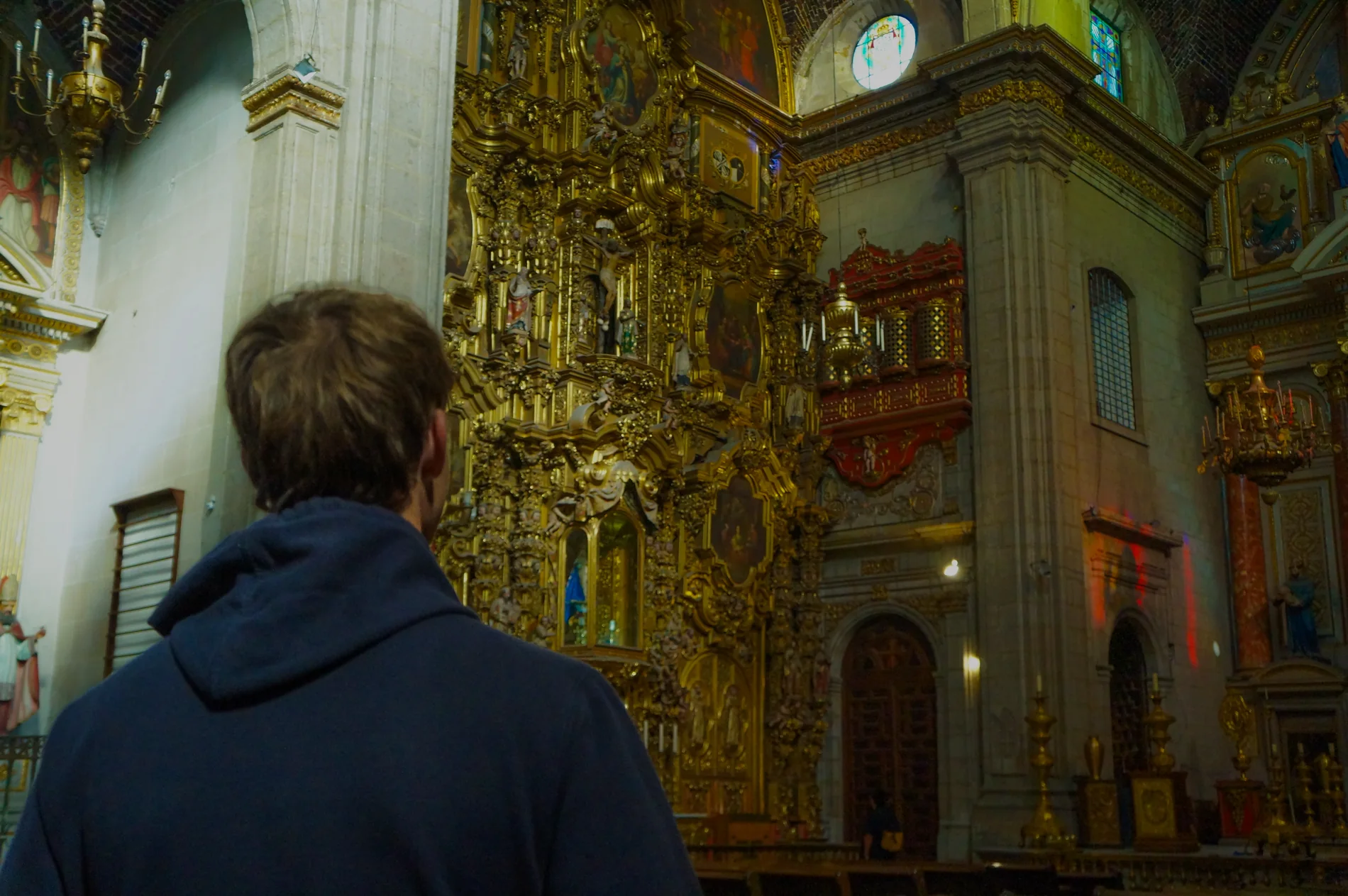 Visitor looking into an ornate church interior
